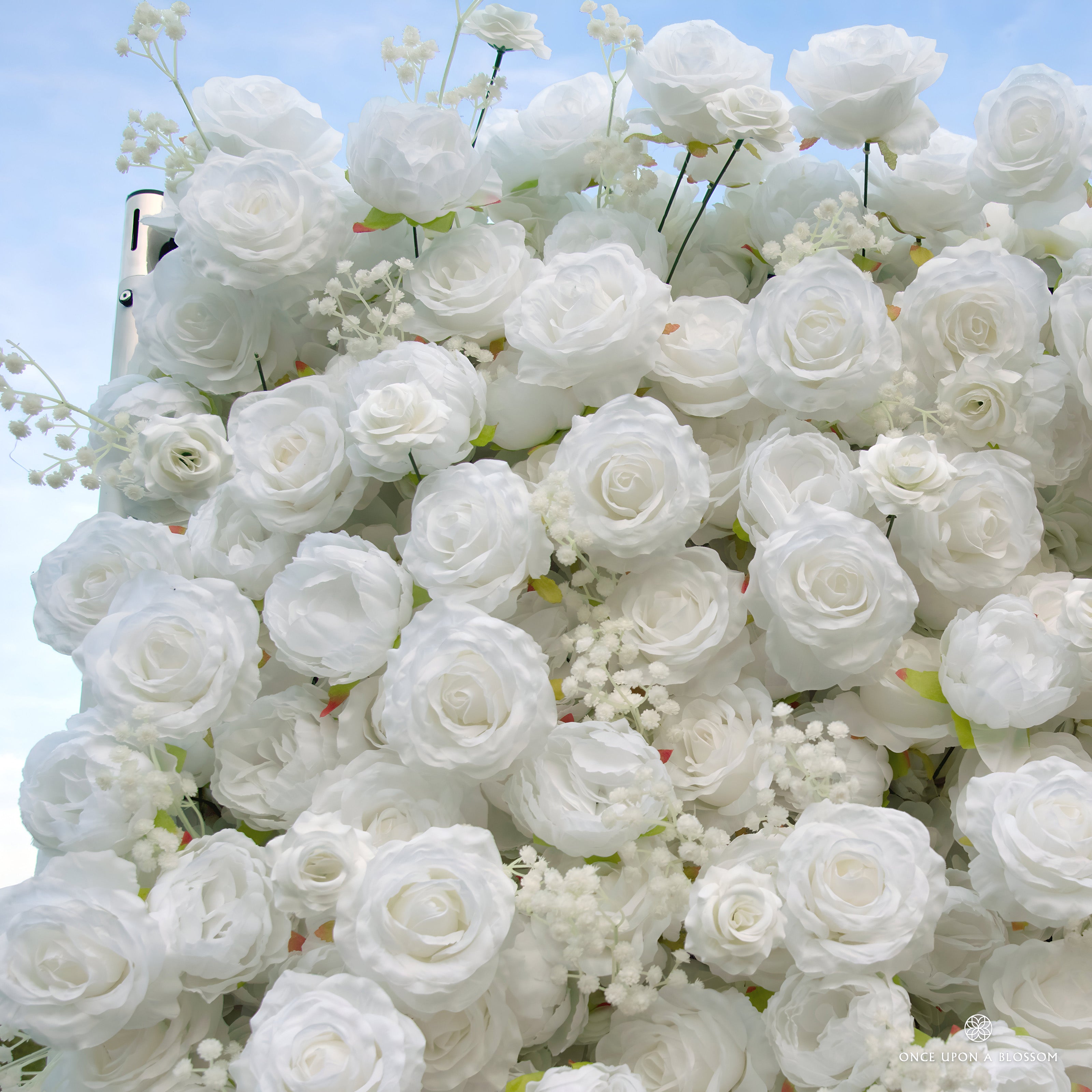 detail shot of petals and foliage of white flower wall featuring white roses, from our Angel’s Breath
