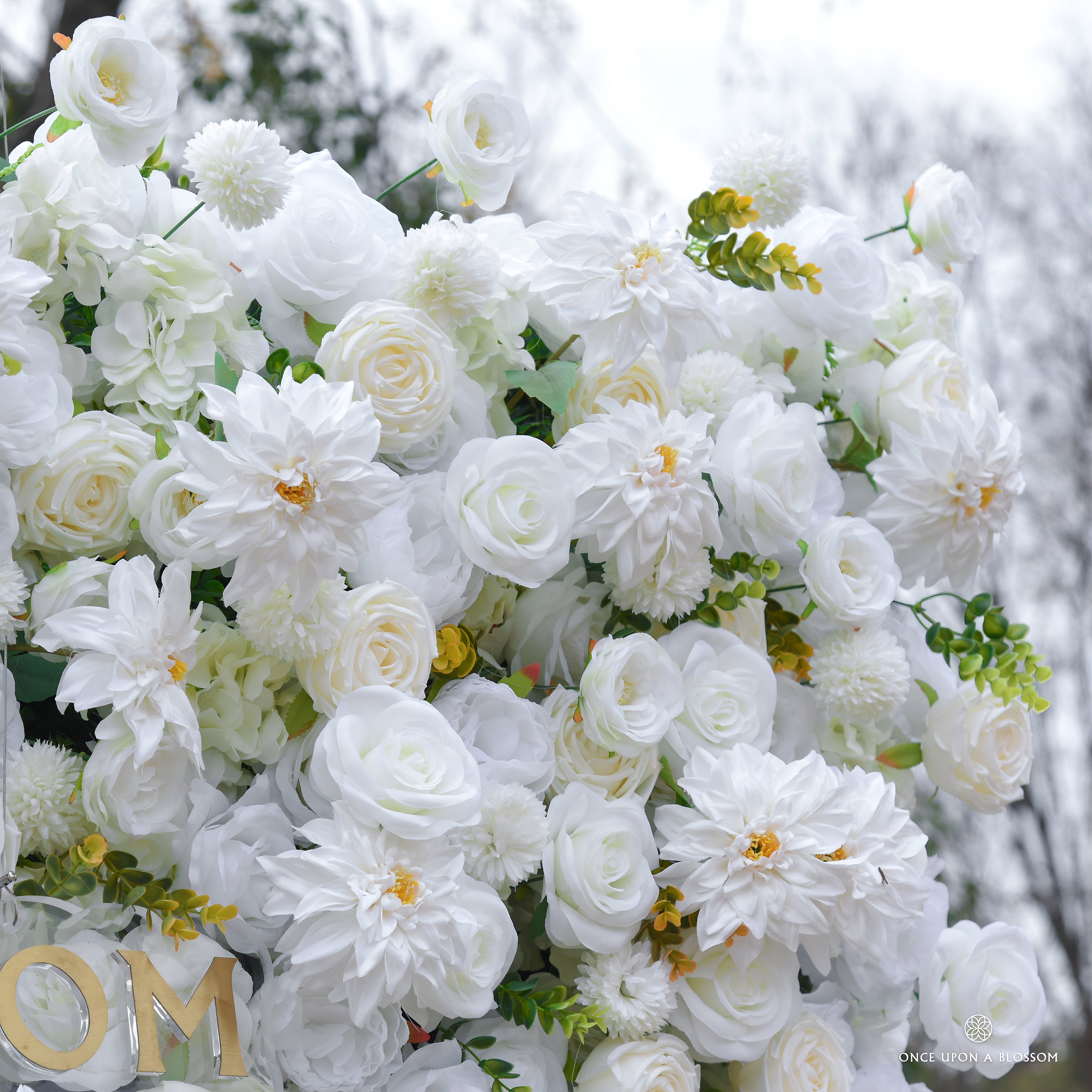 Detail of ivory artificial roses with greenery, showing delicate design of once upon a blossom flower walls