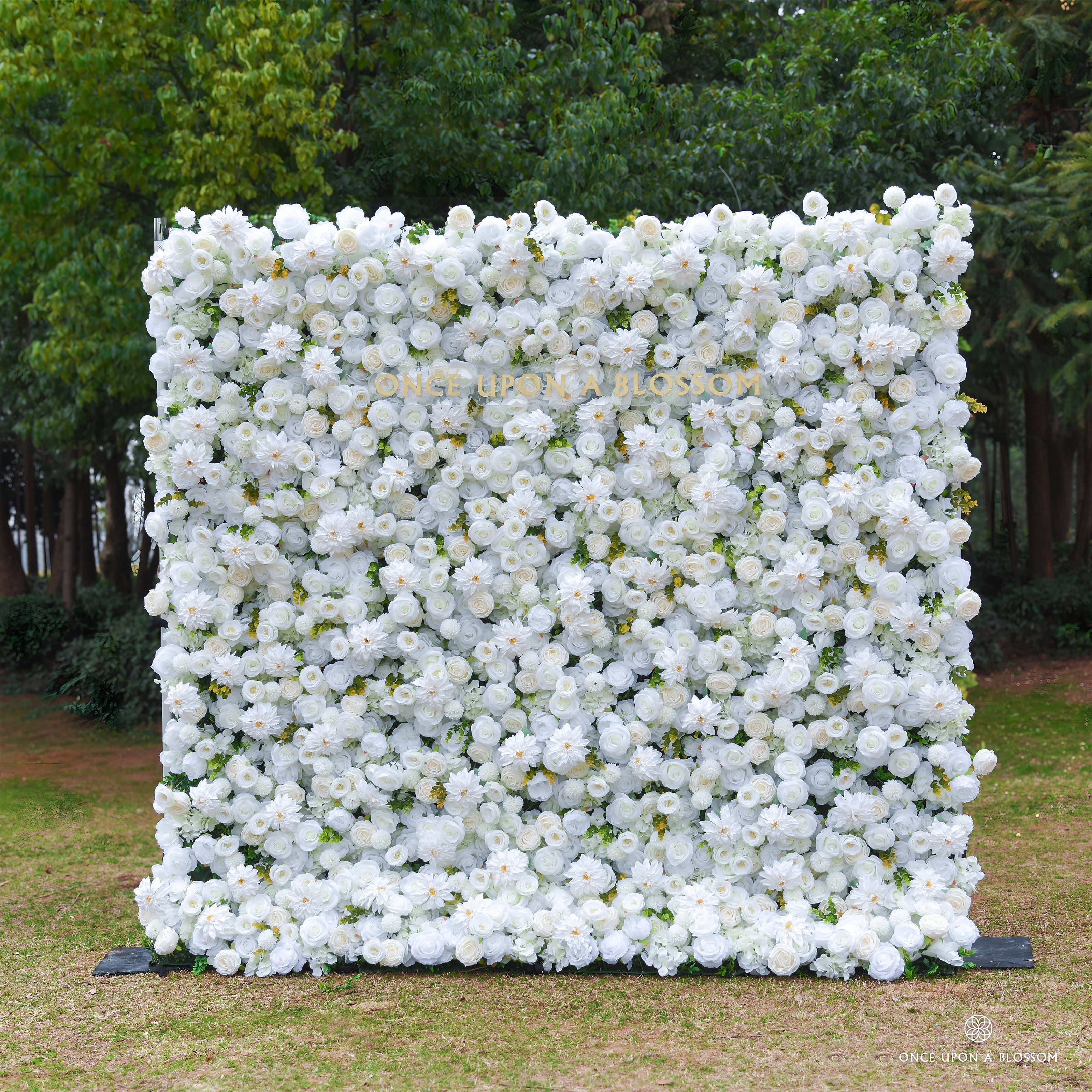 8*8ft floral wall made of white flowers in an outdoor setting with greenery.