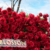 Petal-level detail of the Lover Overload flower wall showing multi-layered florals and natural depth.
