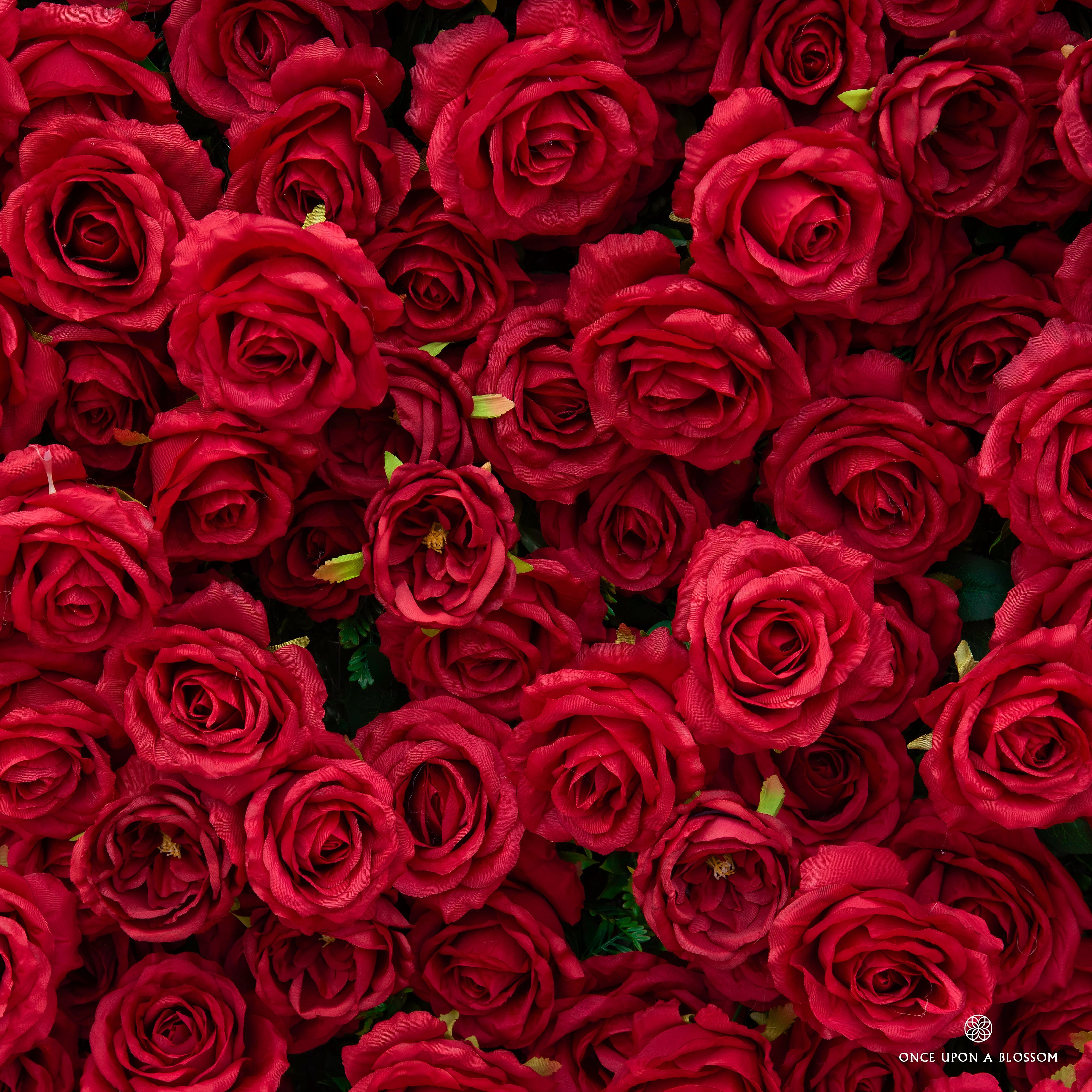 Close-up of realistic silk roses on the Love Overload red flower wall backdrop, showing texture and premium quality.