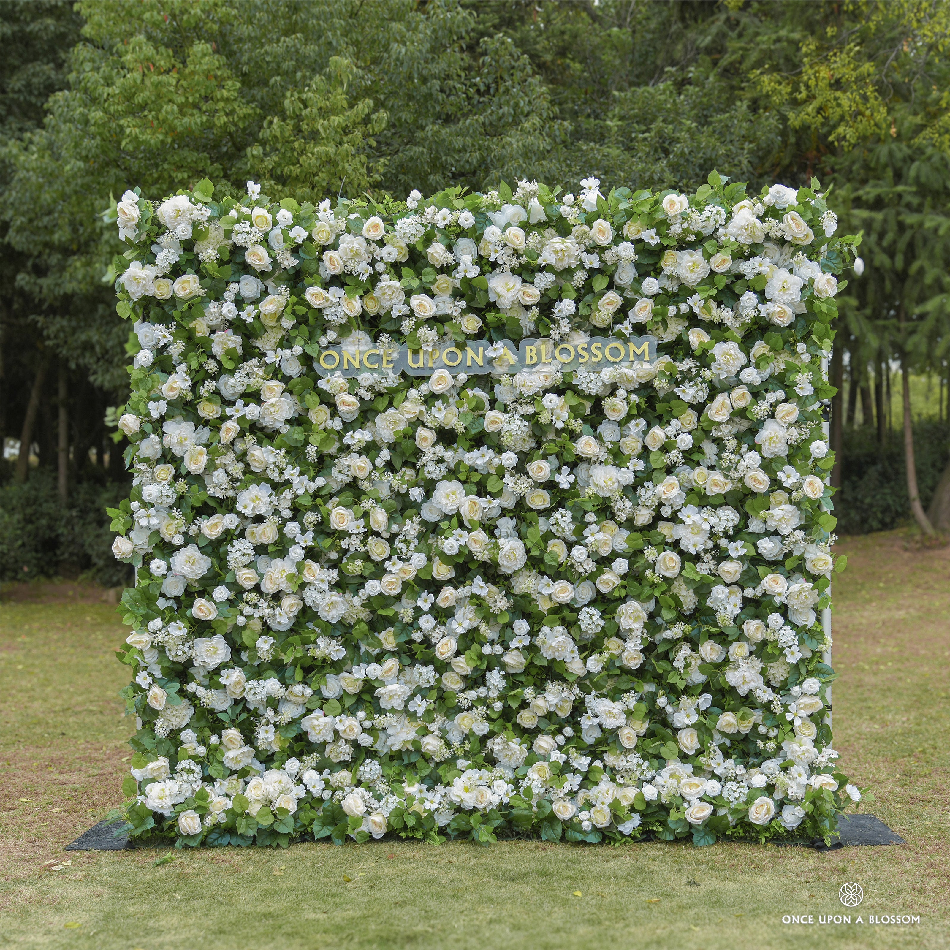Front view of Morning Sunshine ivory flower wall backdrop with greenery base by Once Upon a Blossom — a bright, uplifting flower backdrop for weddings and venues.