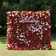 Front view of the Date Night red flower wall backdrop, deep red roses with pink and white accents, set outdoors