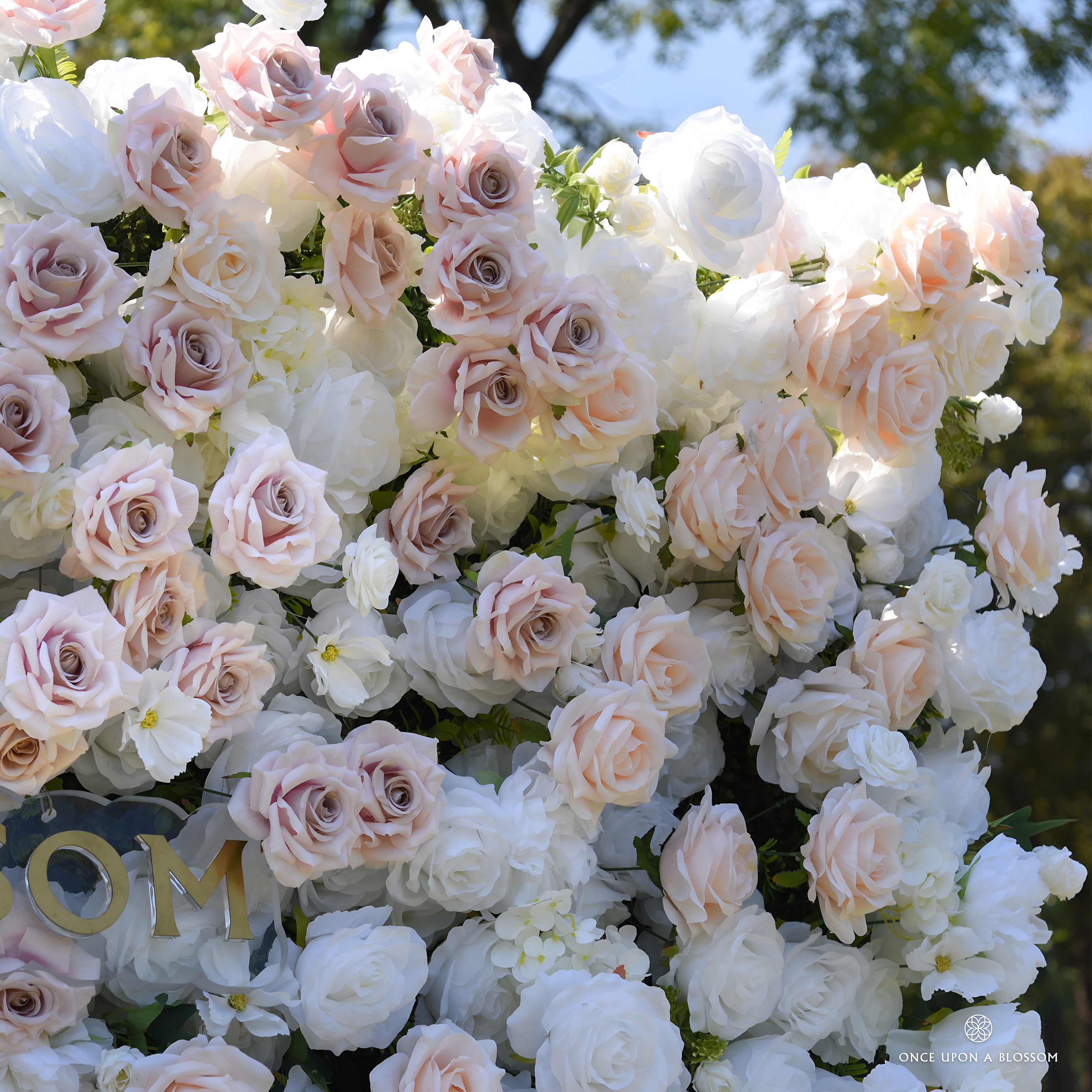 Close-up of white roses with dusty blush and champagne roses on the First Blush wedding flower wall