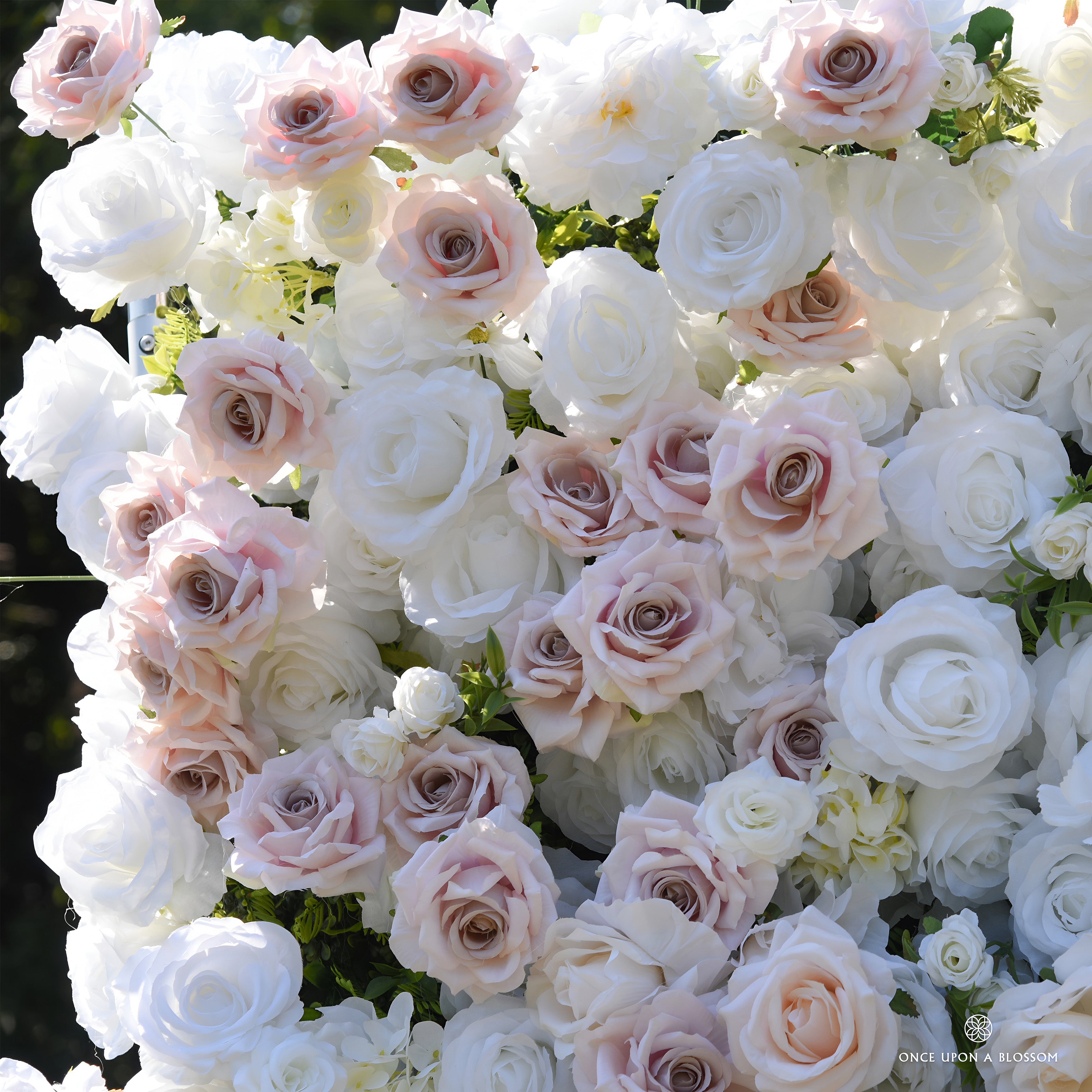 Detail of dusty blush and white silk roses with small white blossoms on the First Blush flower wall