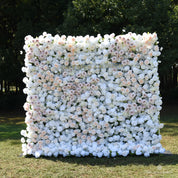 Front view of the First Blush white flower wall backdrop with blush and champagne roses, set outdoors