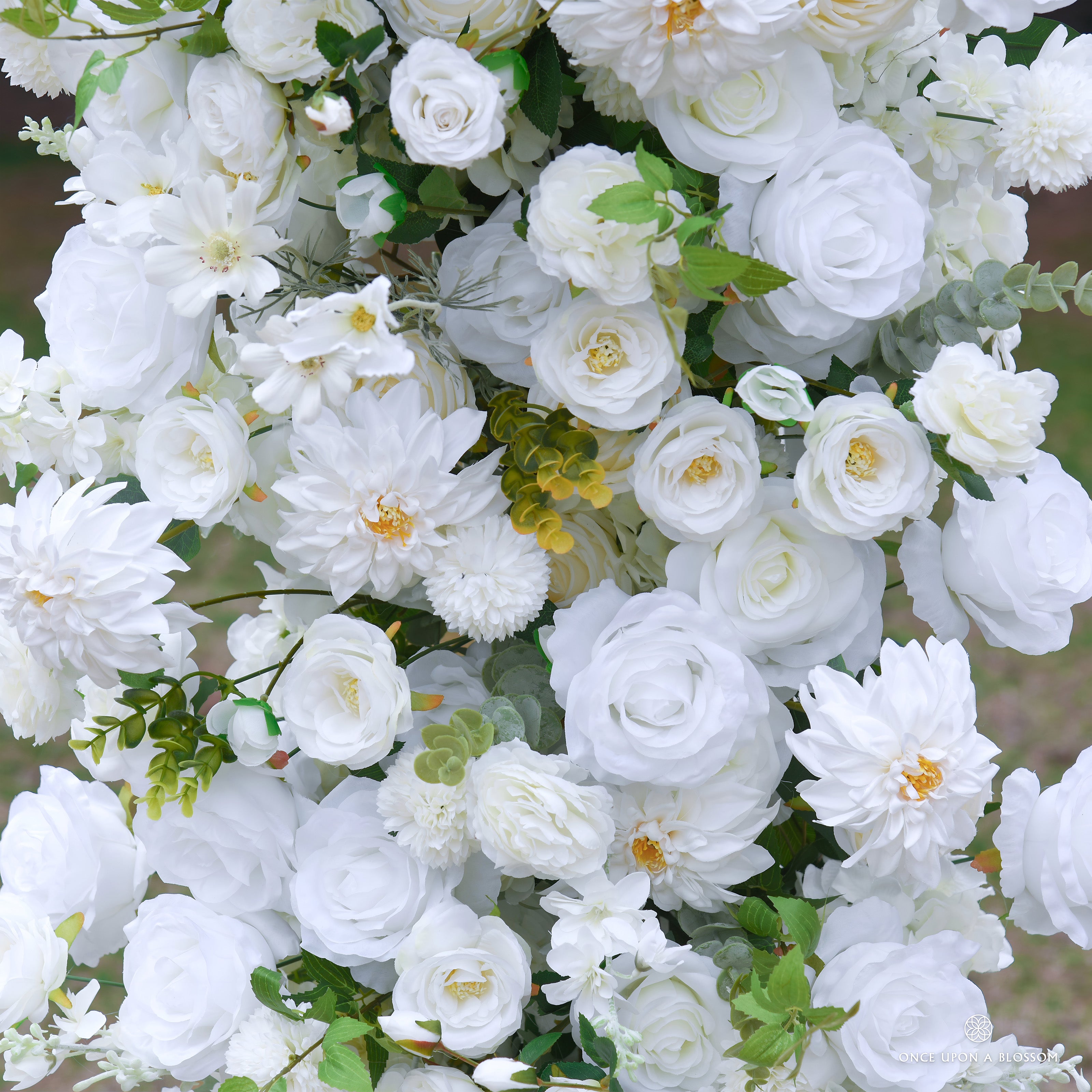 flower arch of ivory flowers with green leaves