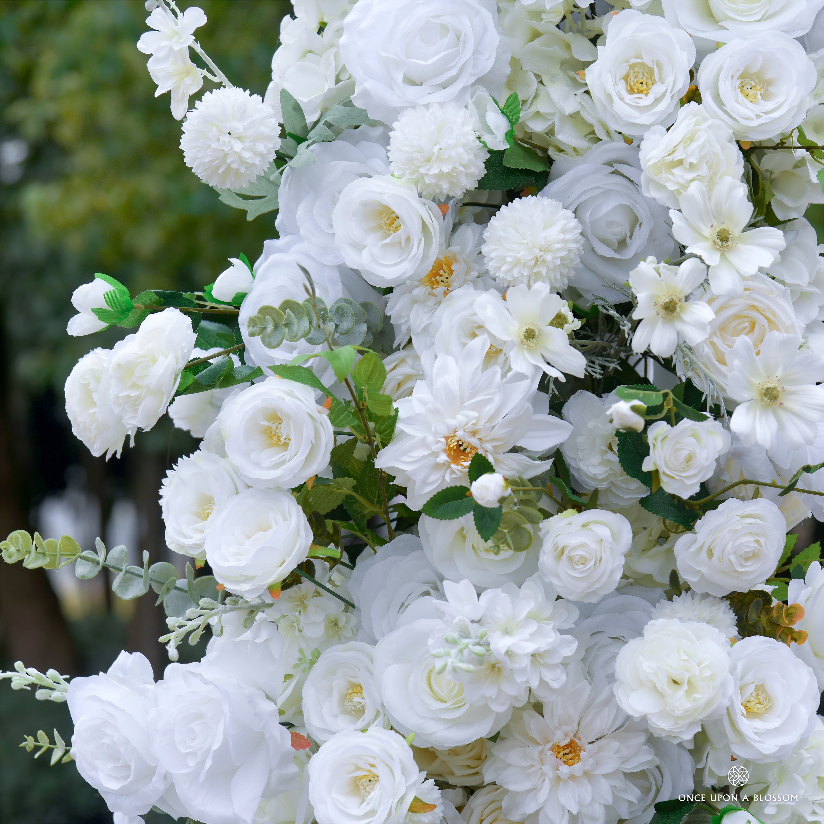 Close-up of a flower arch of ivory flowers with green leaves