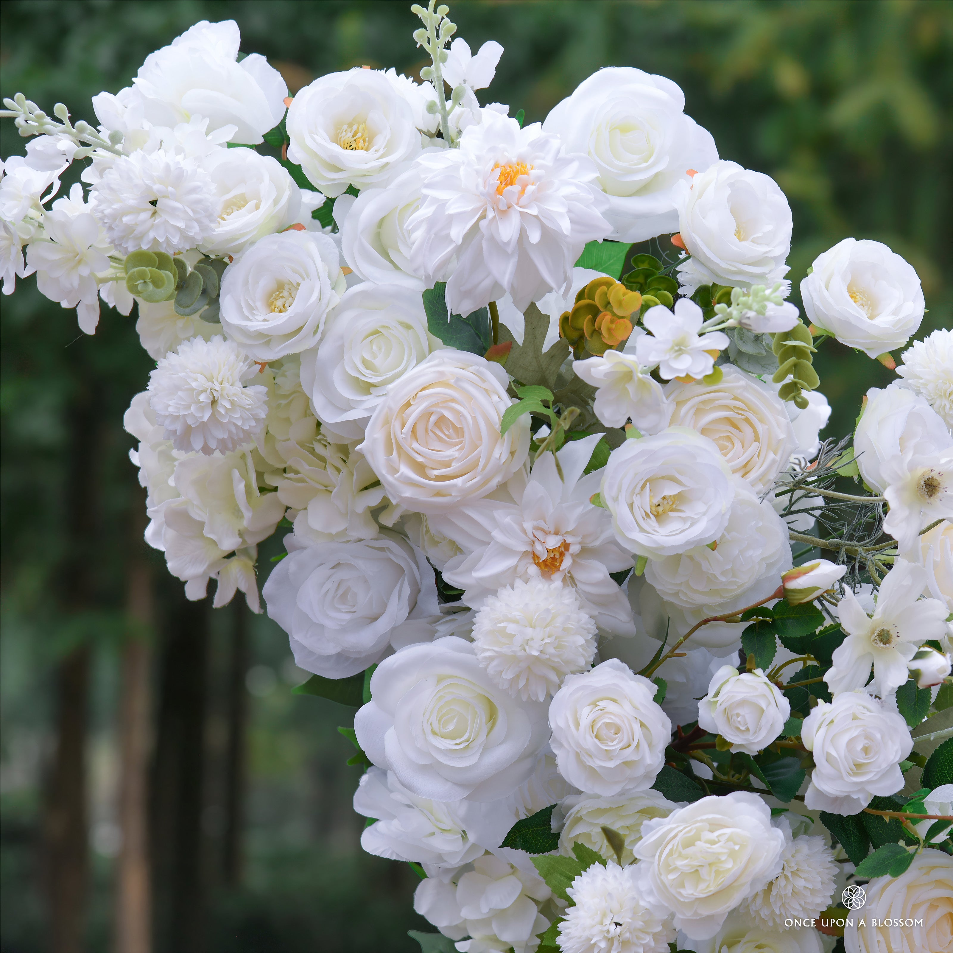 arch of white flowers with greenery, designed for weddings