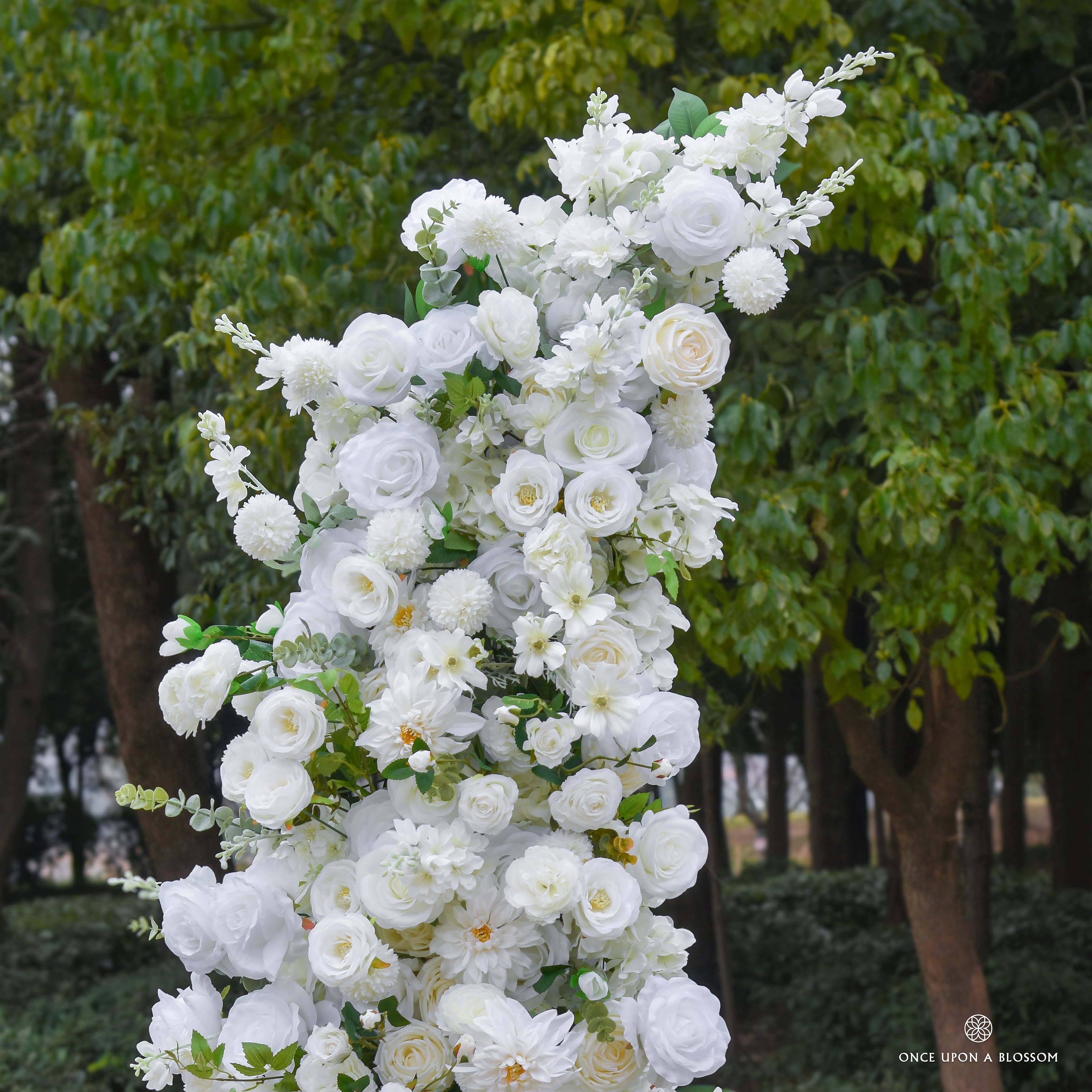 White floral archway with greenery, made for weddings, venues, and events