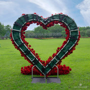 Back view of Pulse red flower arch showing construction details—fabric base with flowers attached, secured by straps and velcro.