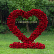 Front view of red heart-shaped flower arch Pulse with deep red silk roses.