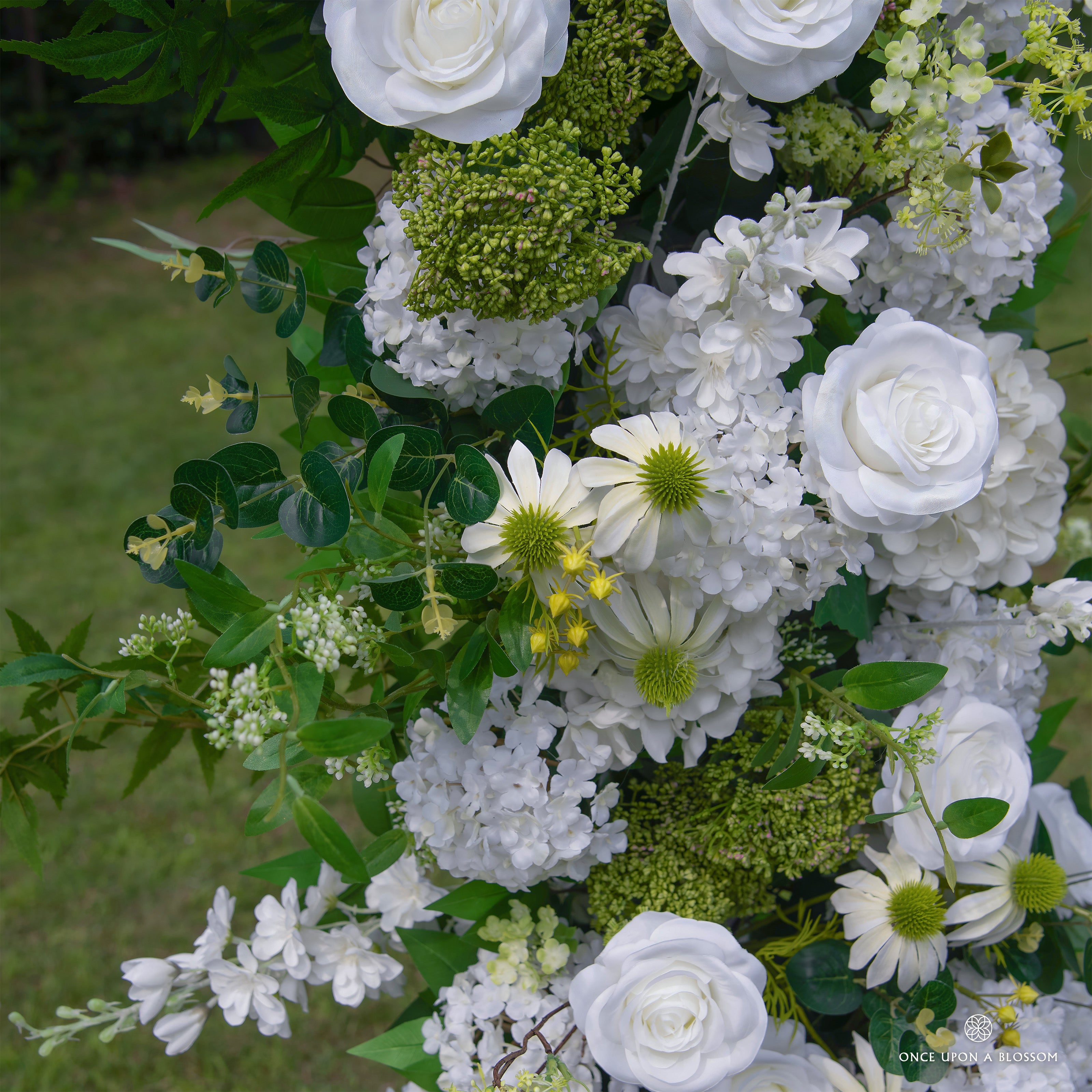Detail shot of Be Here Now white flower arch—premium materials and design.