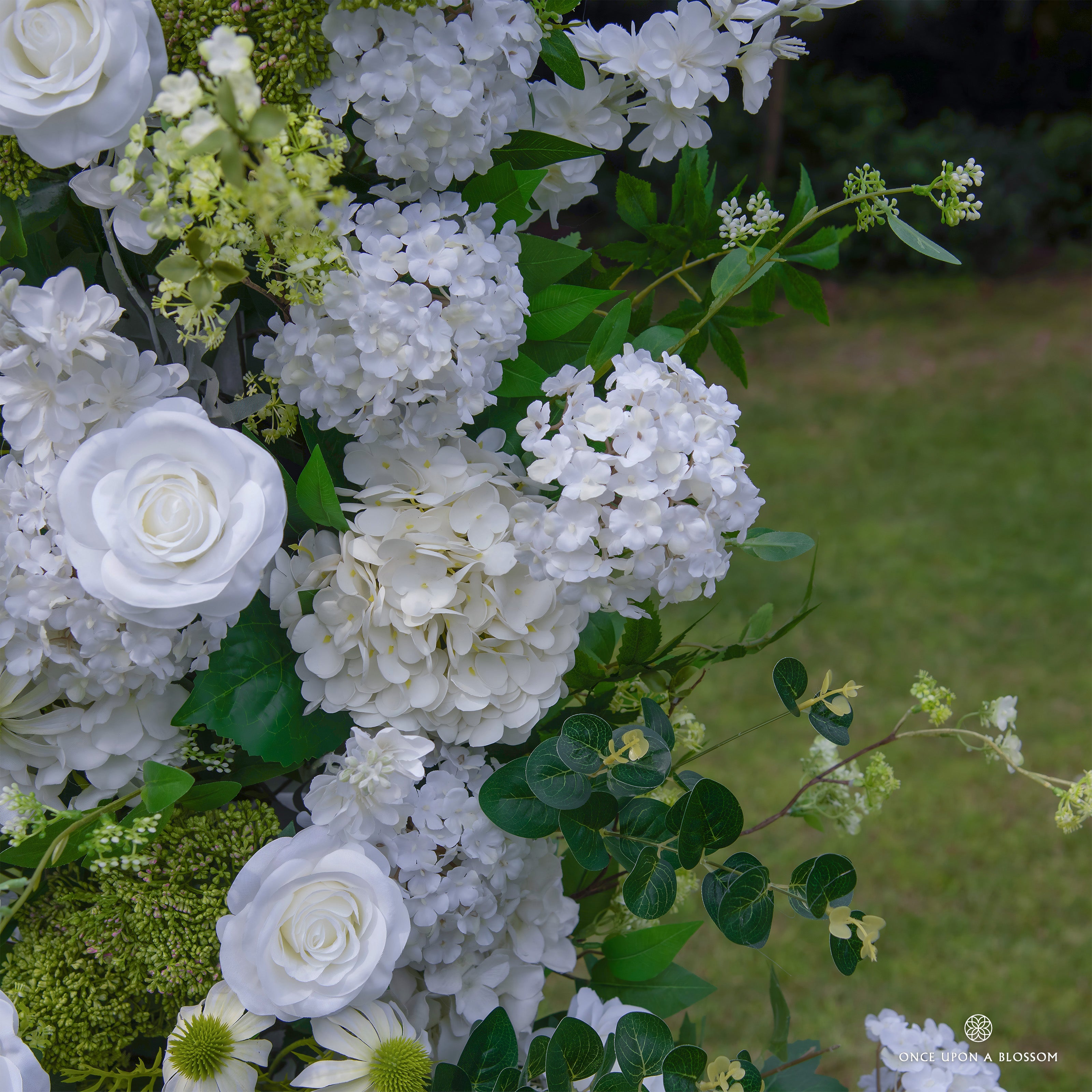 Detailed view of Be Here Now flower arch—premium white roses and hydrangeas.