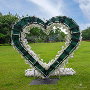 Back view of Echo white flower arch showing construction details—fabric base with flowers attached, secured by straps and velcro.