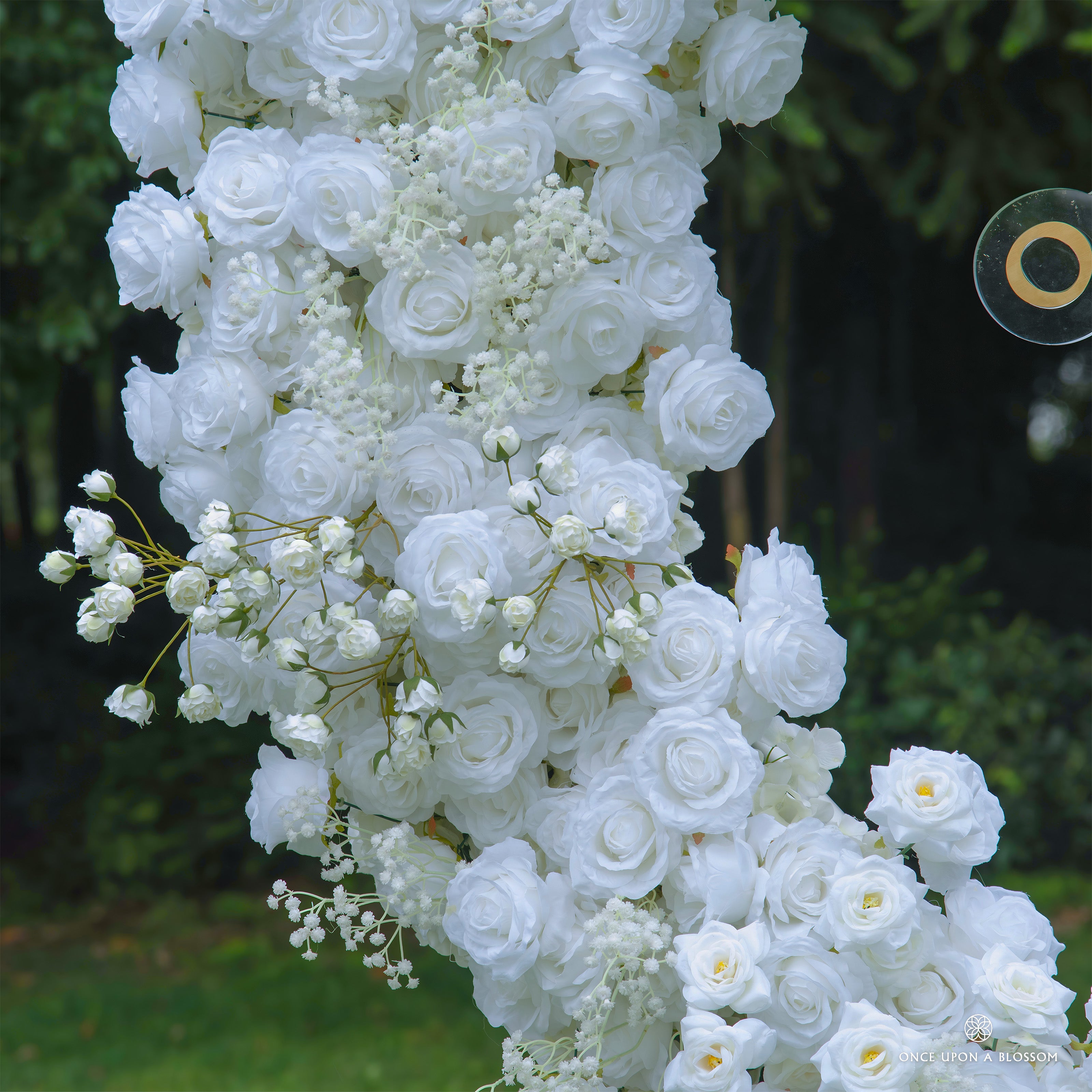 Close-up of flower arch—pure white roses with lifelike petals and rich texture.