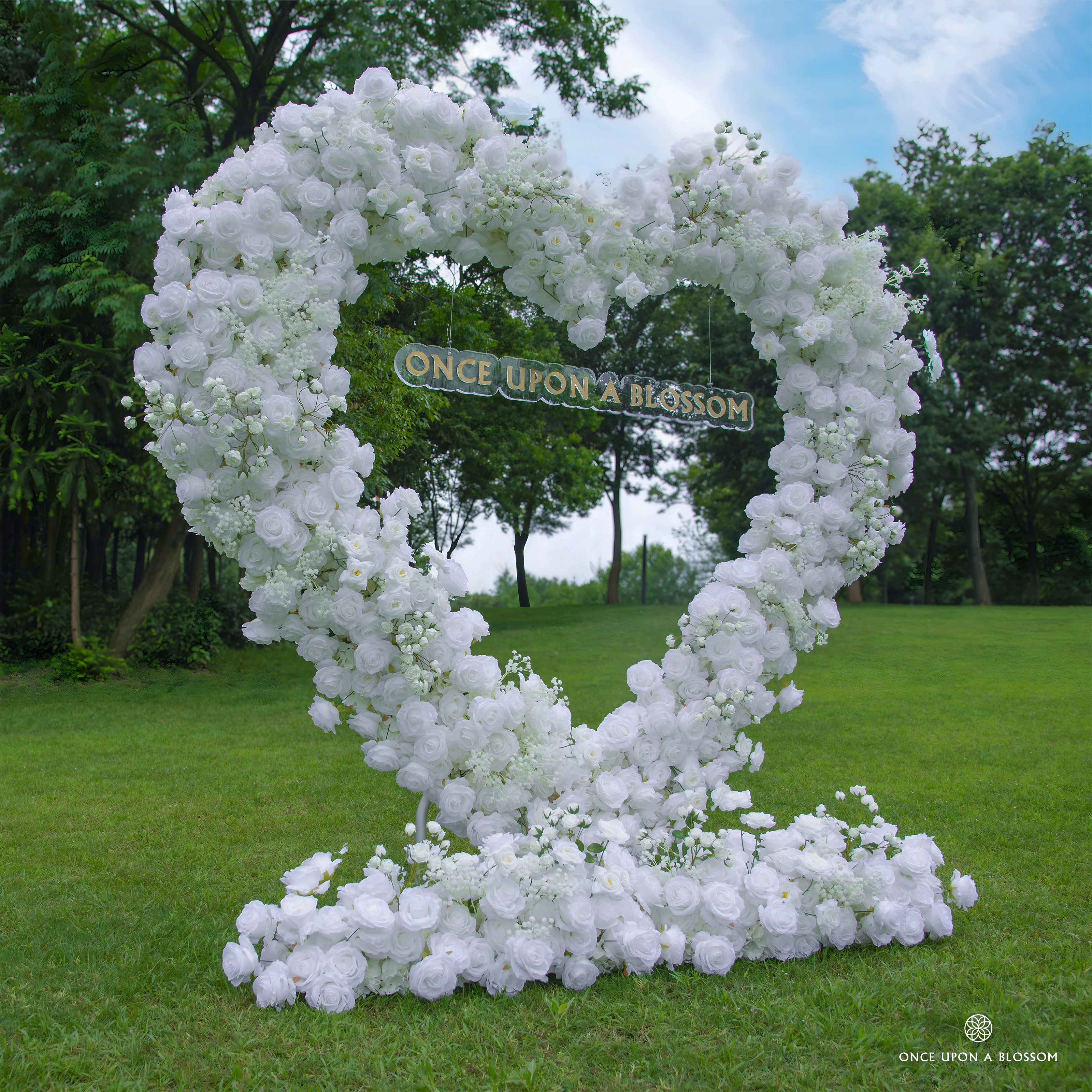 Left side of flower arch showing pure white roses and heart-shaped frame.