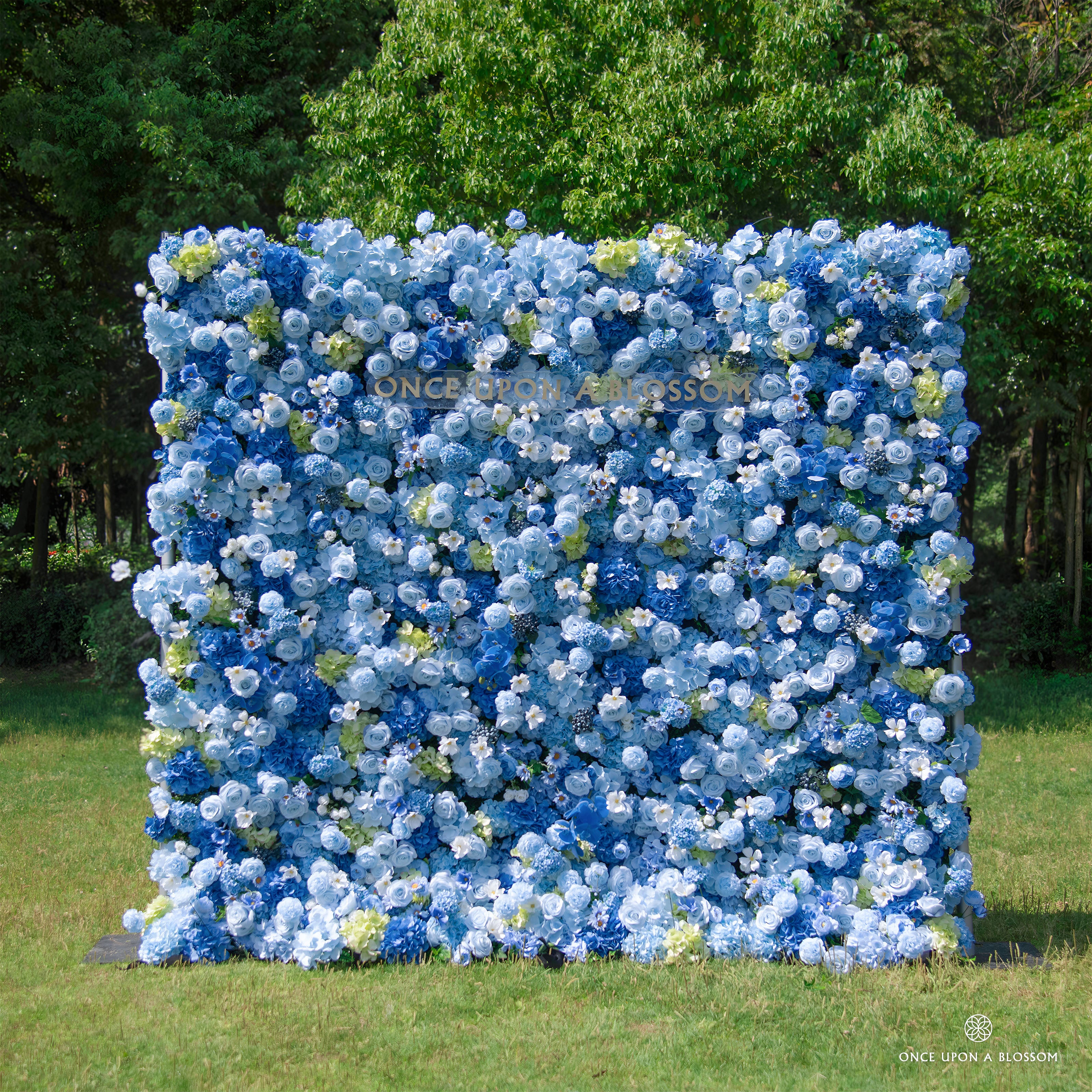 front view of blue and white flower wall featuring hydrangeas and roses, from our Something Blue.