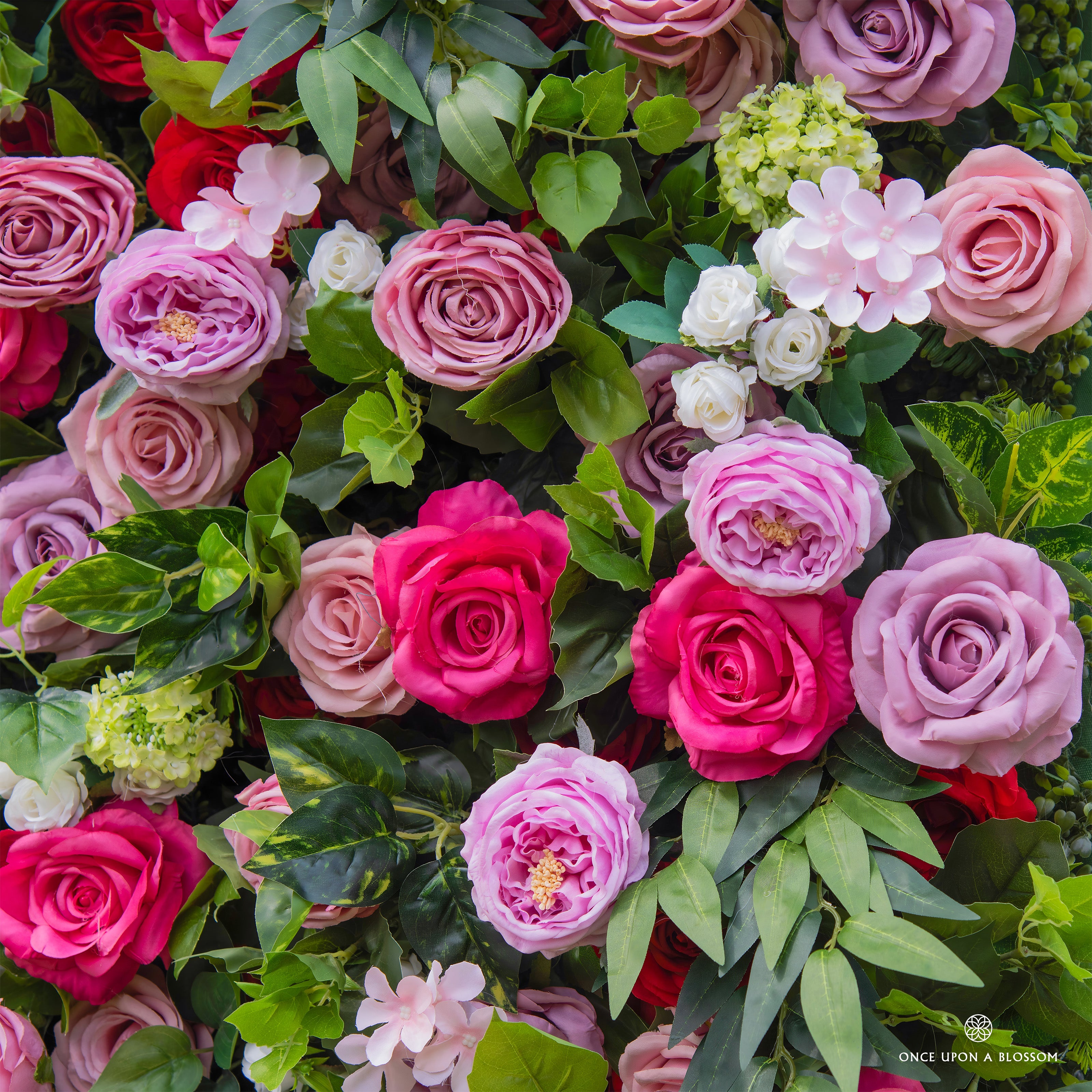 Close-up of lush berry-toned florals from Summer Sangria flower wall.