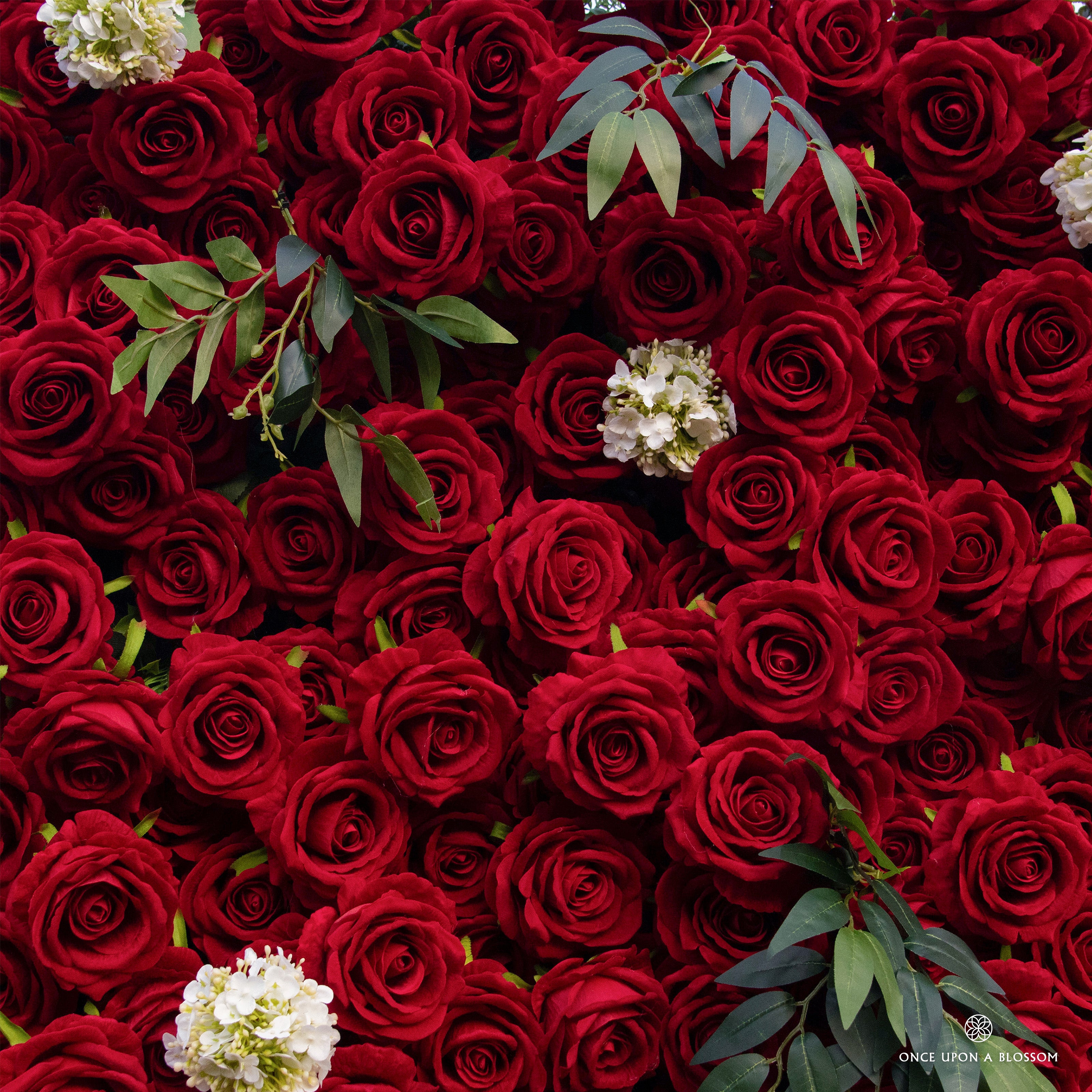 detail shot of petals and foliage of red and green flower wall featuring premium red roses, from our Lost Roses