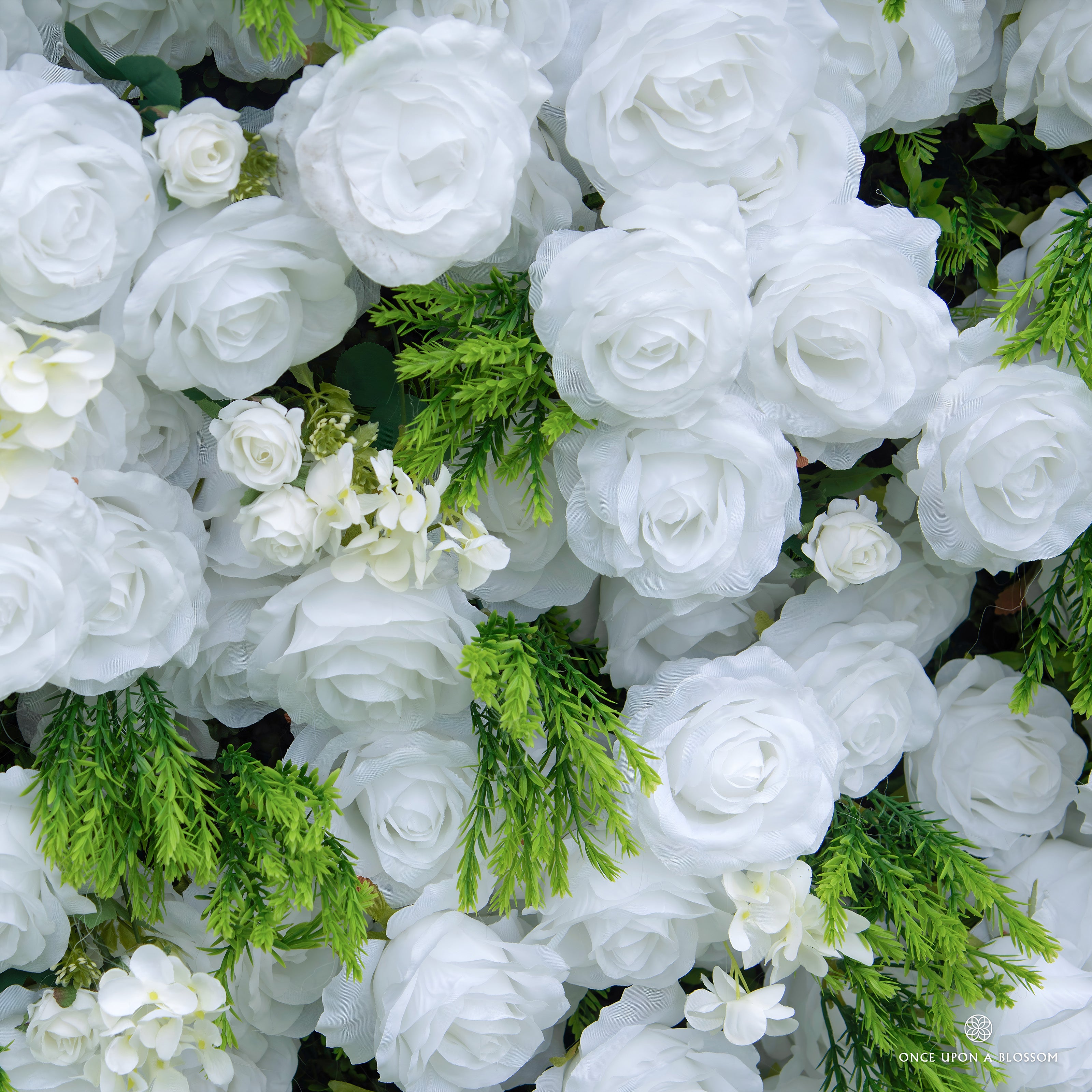 Close-up of white roses and greenery featured on Garden Party photo booth backdrop