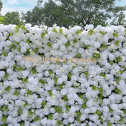 White flowers and greenery featured on Garden Party photo booth backdrop