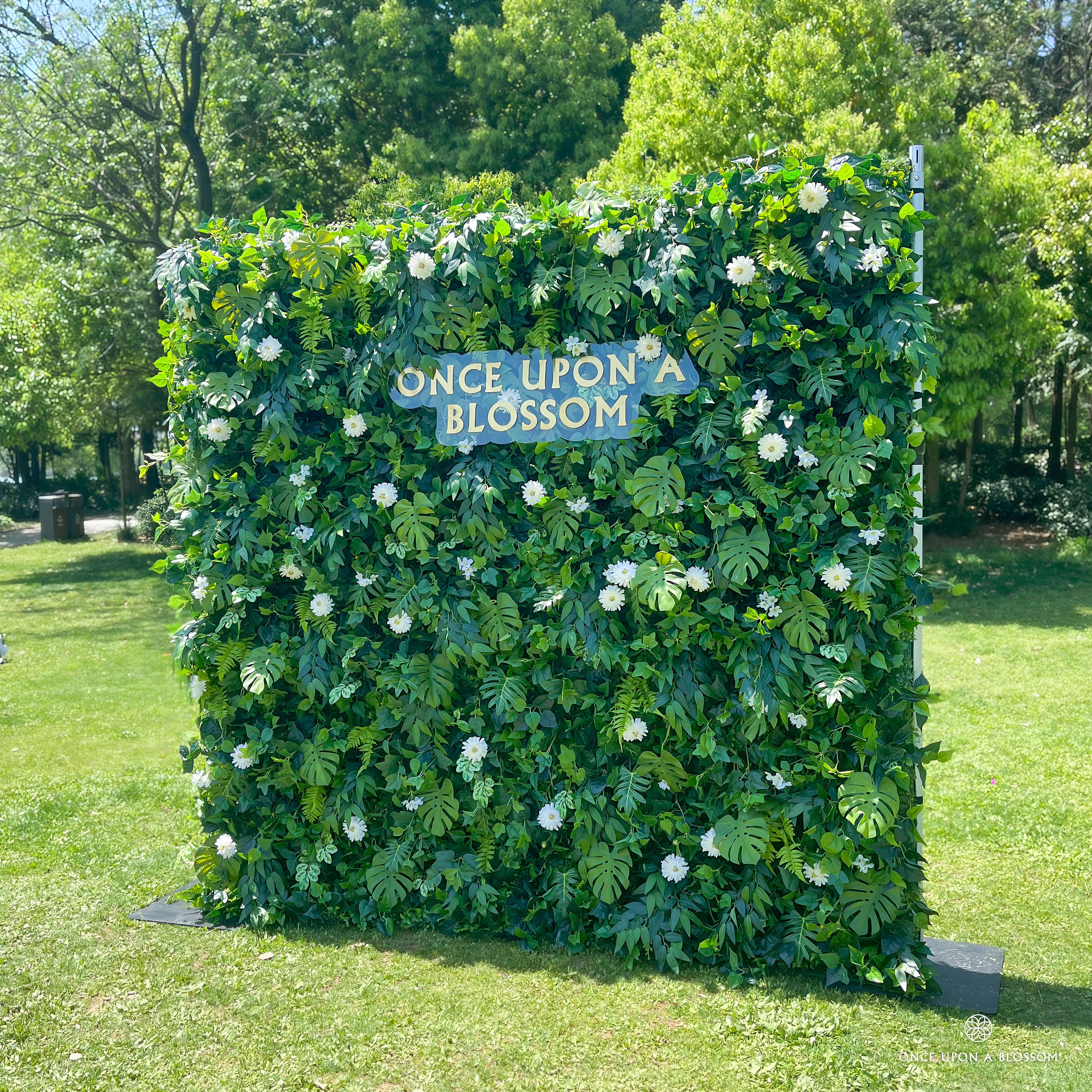 right-side angle of greenery wall featuring chrysanthemums, pothos, and monstera leaves, from our Pearl Garden.