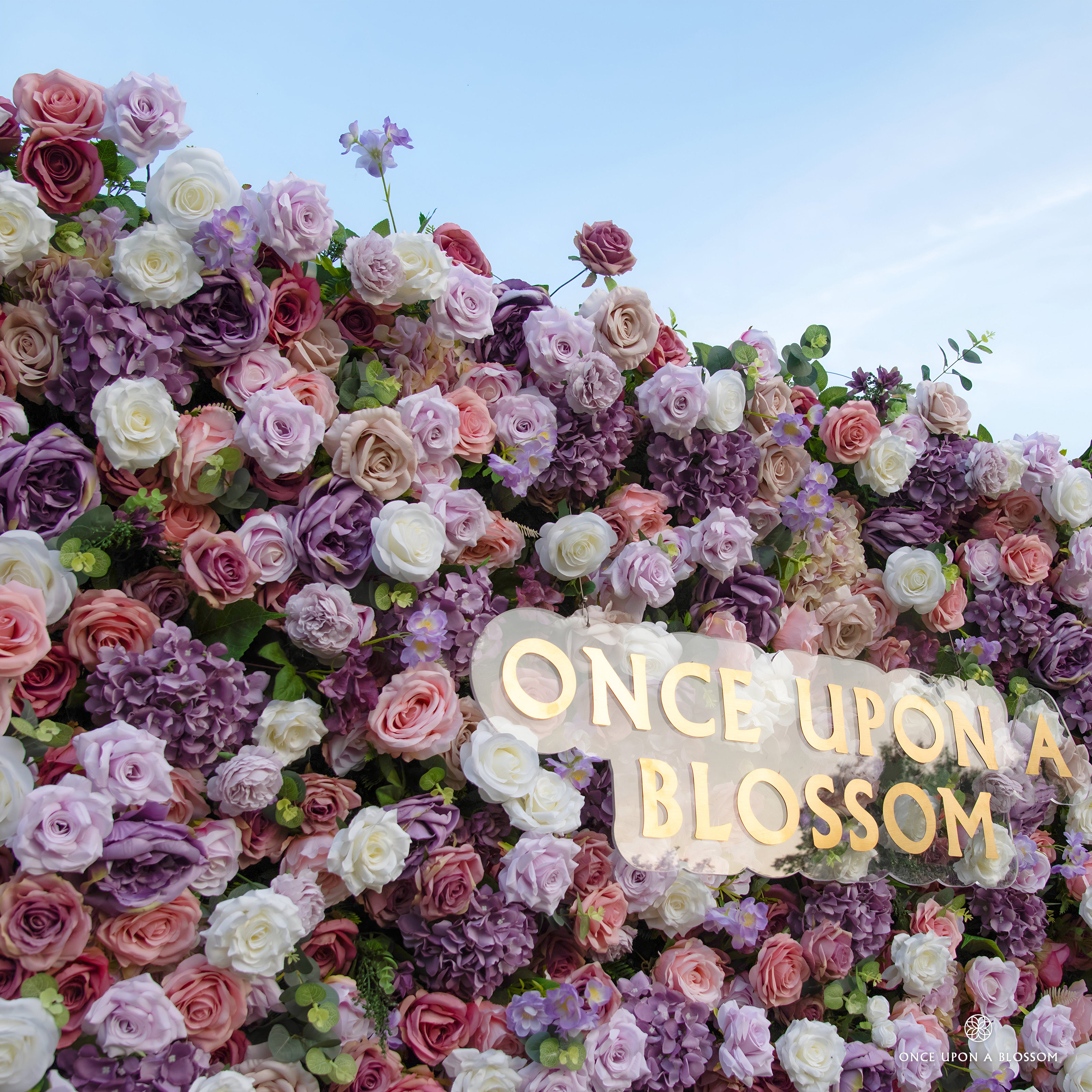 detail shot of petals and foliage of purple, pink, and white flower wall featuring roses, from our Purple Velvet.