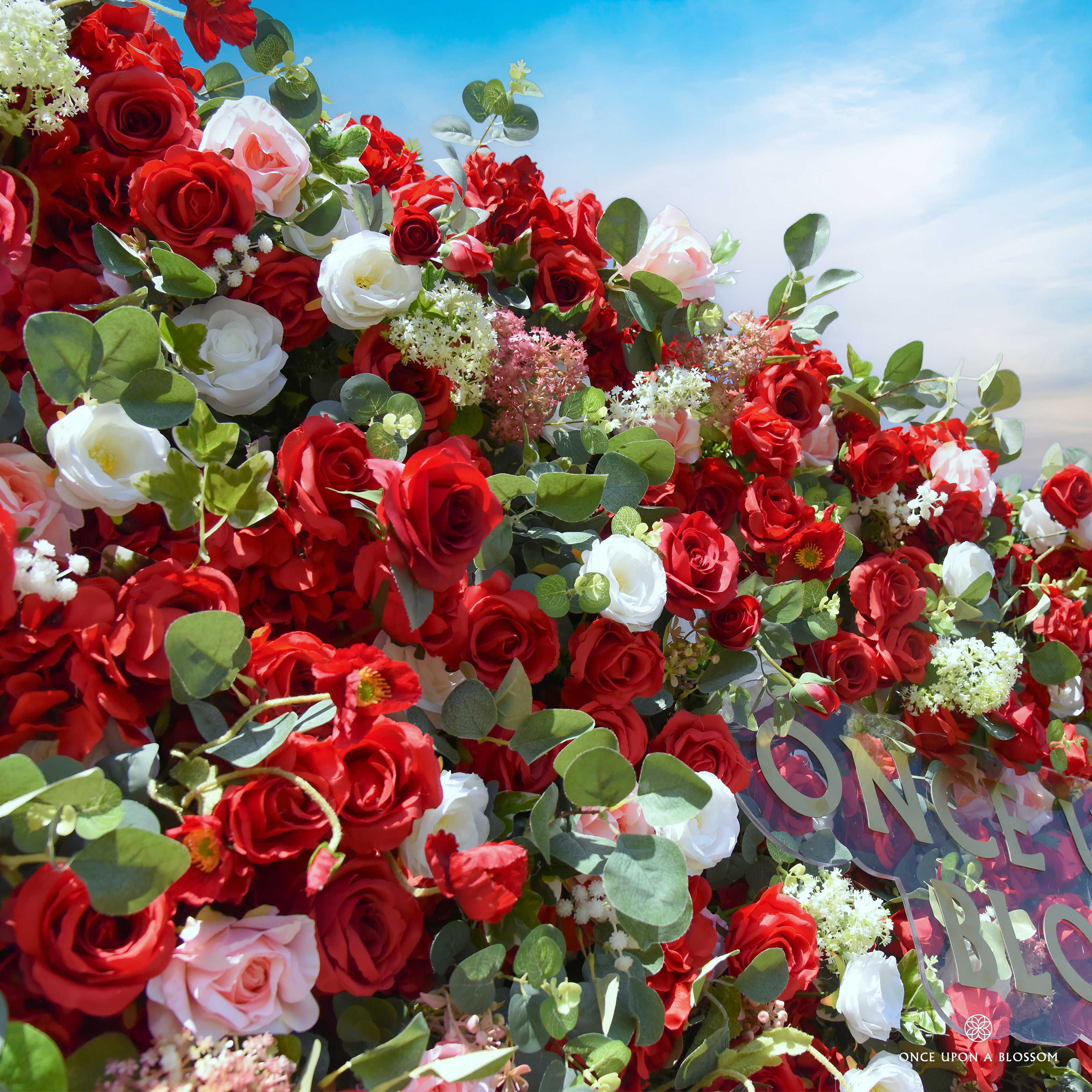 close-up of flower textures of red, white, and green flower wall featuring roses and greenery, from our Ruby Rouge.