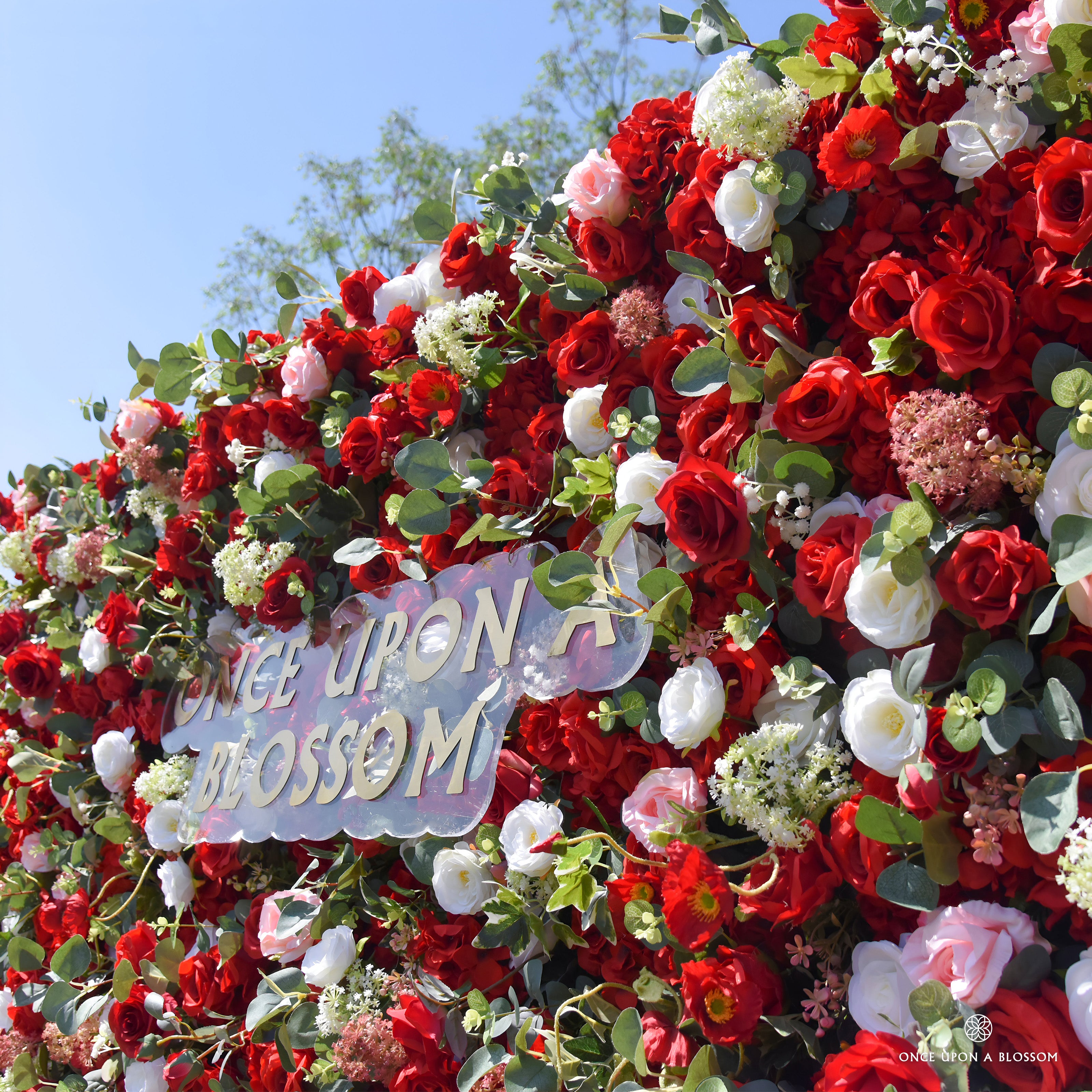 close-up of flower textures of red, white, and green flower wall featuring roses and greenery, from our Ruby Rouge.