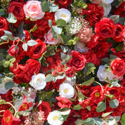 detail shot of petals and foliage of red, white, and green flower wall featuring roses and greenery, from our Ruby Rouge.