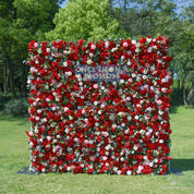 front view of red, white, and green flower wall featuring roses and greenery, from our Ruby Rouge.