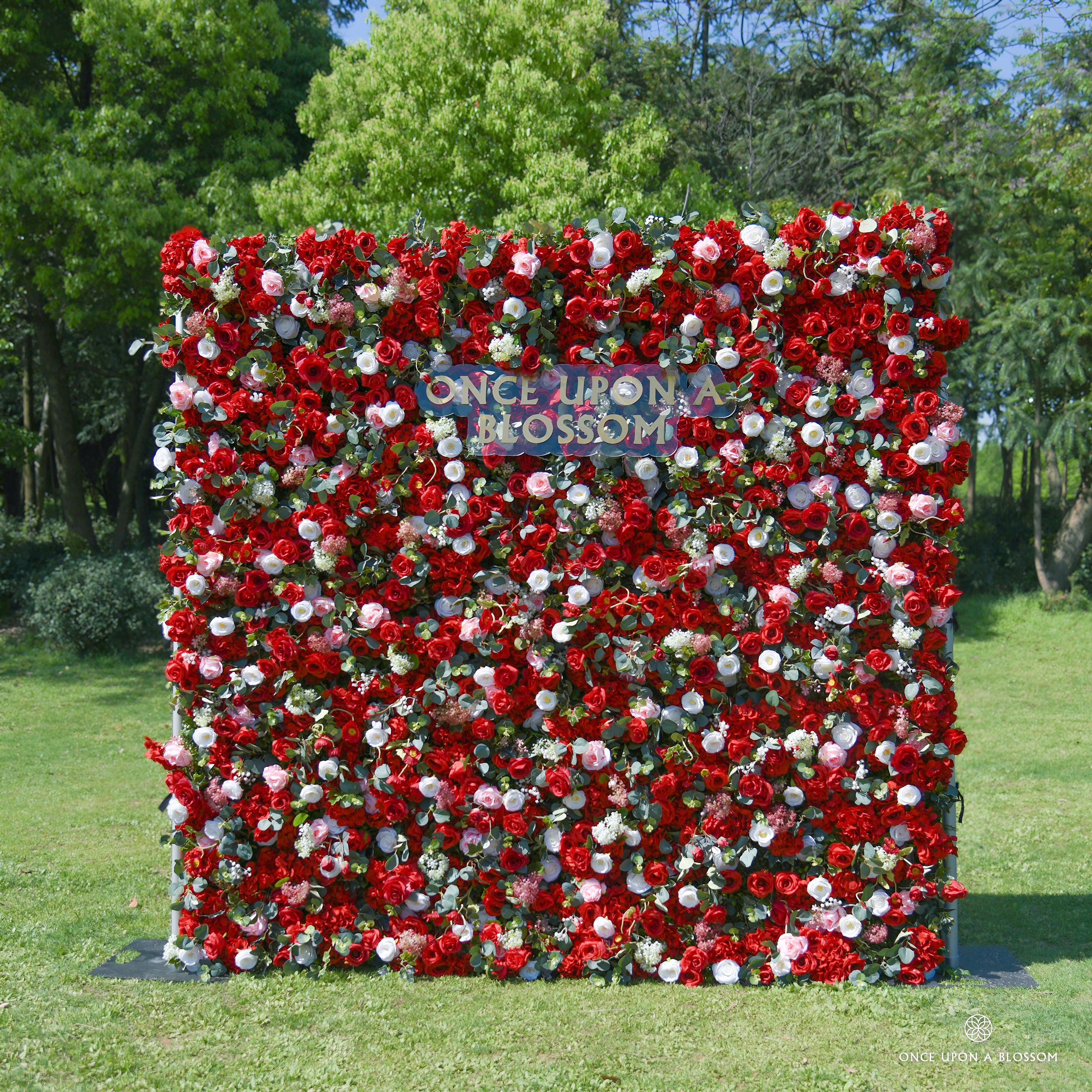 front view of red, white, and green flower wall featuring roses and greenery, from our Ruby Rouge.