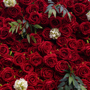 detail shot of petals and foliage of red and green flower wall featuring premium red roses, from our Lost Roses